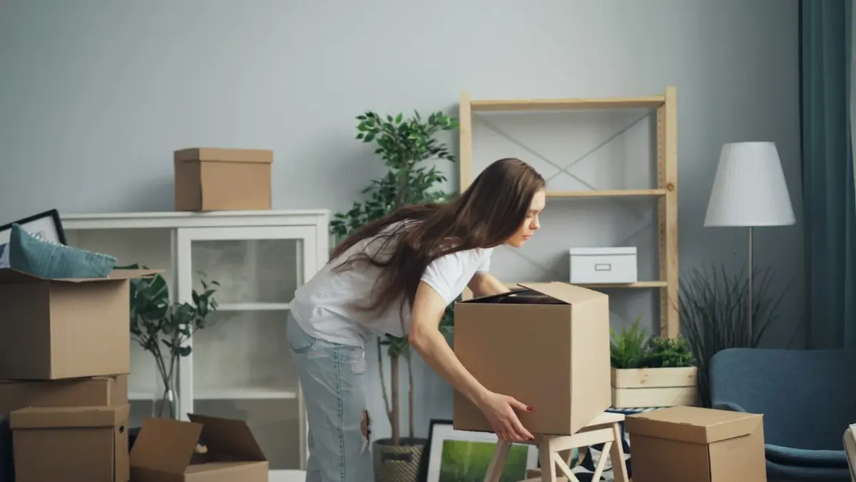 Mujer empaquetando una caja en el salón